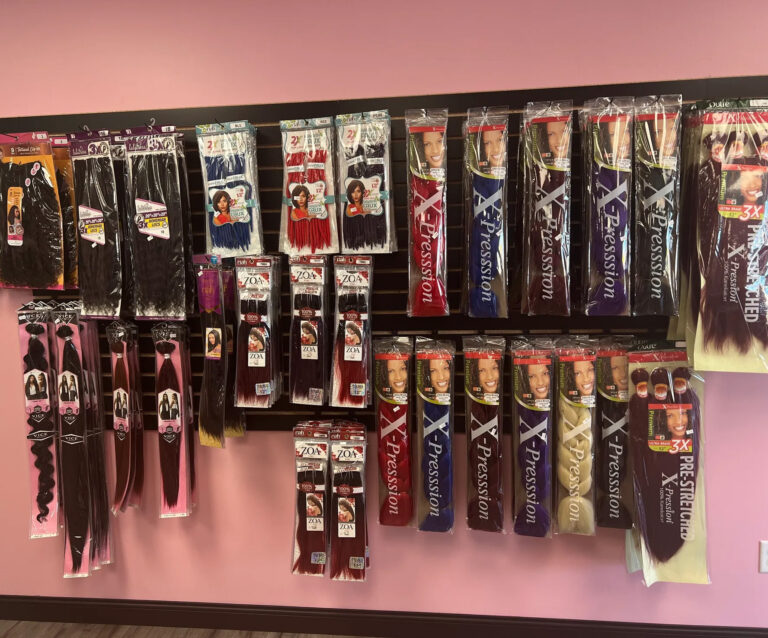 Hair extensions hanging on a retail wall rack