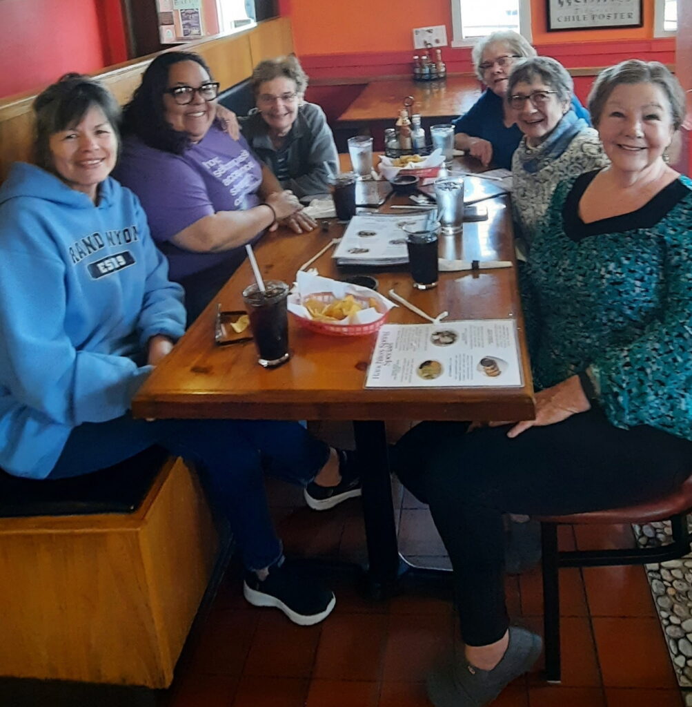 group of 6 women seated at a restaurant table